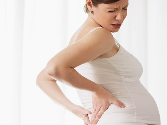 Болит поясница при беременности на третьем месяце